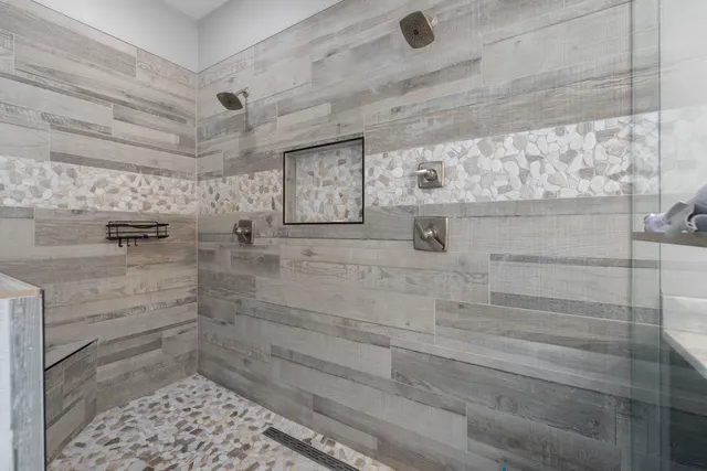 a spacious bathroom with a tub double vanity sink and mirrors