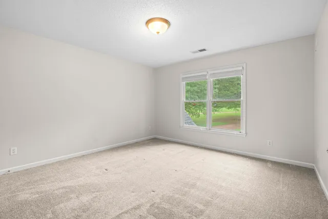 a bedroom with bed and a window