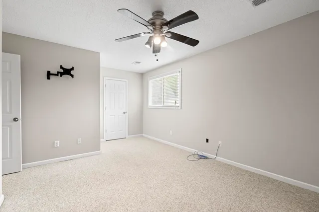 a bathroom with a granite countertop sink and a toilet