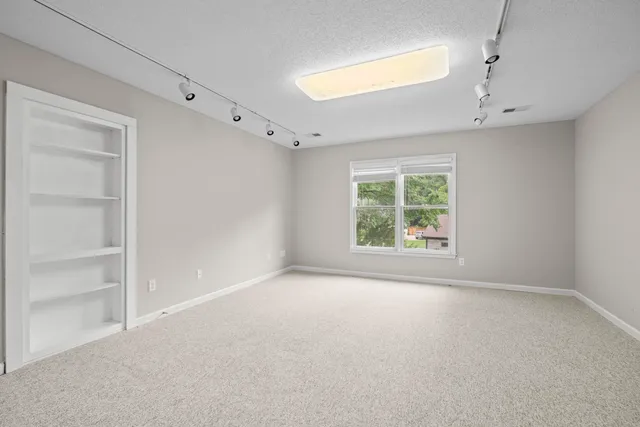 a view of an empty room with a ceiling fan