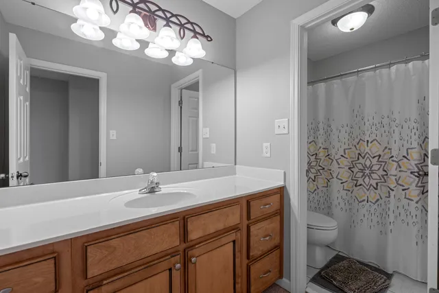 a view of a livingroom with a ceiling fan and window