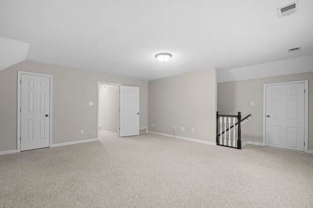 a bathroom with a granite countertop sink a toilet and a mirror