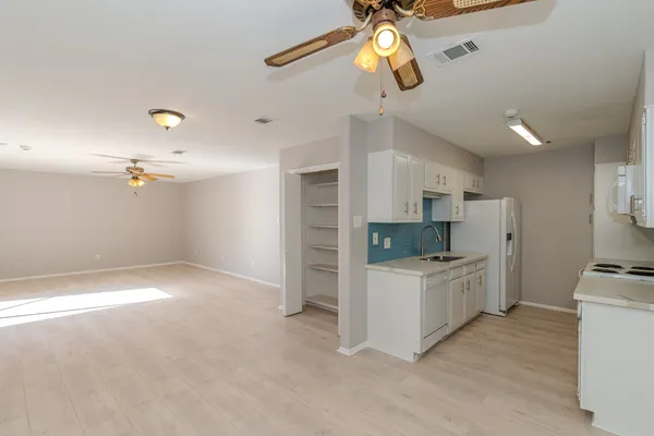 a kitchen with a refrigerator and a stove top oven