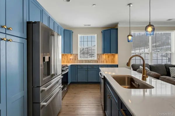 a kitchen with stainless steel appliances granite countertop a refrigerator and a sink