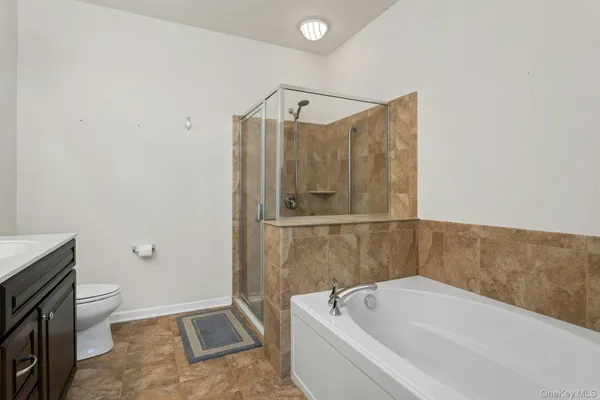 a bathroom with a bathtub a toilet and a shower