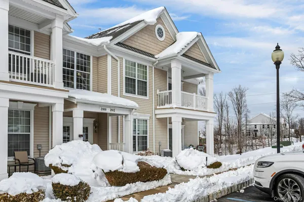 a front view of a house with outdoor seating space