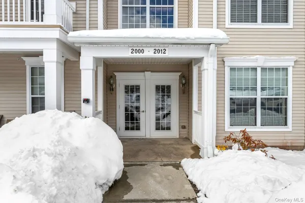 a view of a white building with large windows