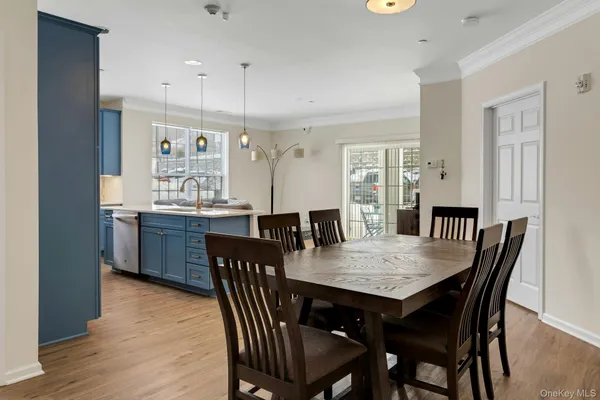 a dining room with stainless steel appliances a table and chairs