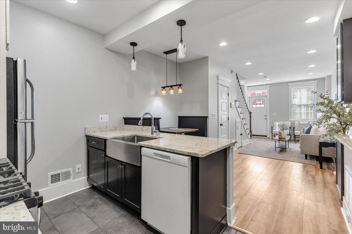 635 20th Street Northeast Washington, DC 20002 - Photo 12 of 33 a kitchen with granite countertop a sink appliances and cabinets