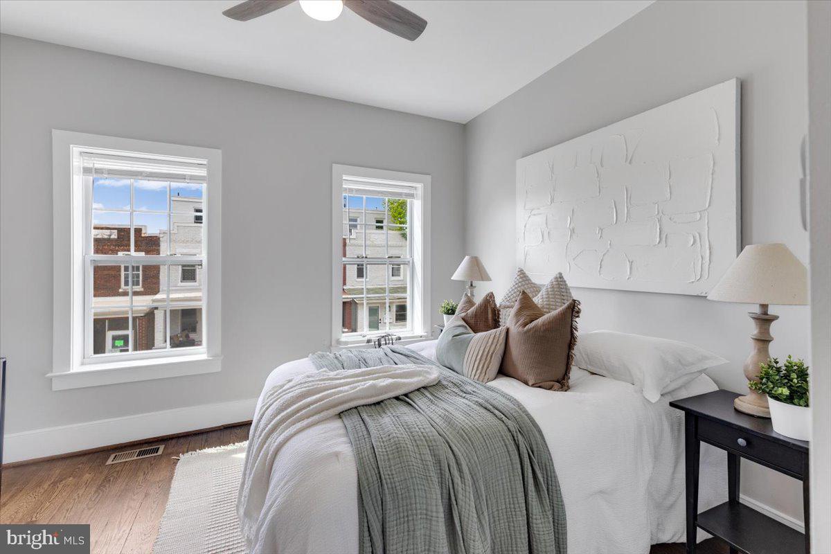635 20th Street Northeast Washington, DC 20002 - Photo 15 of 33 a bedroom with a bed and wooden floor