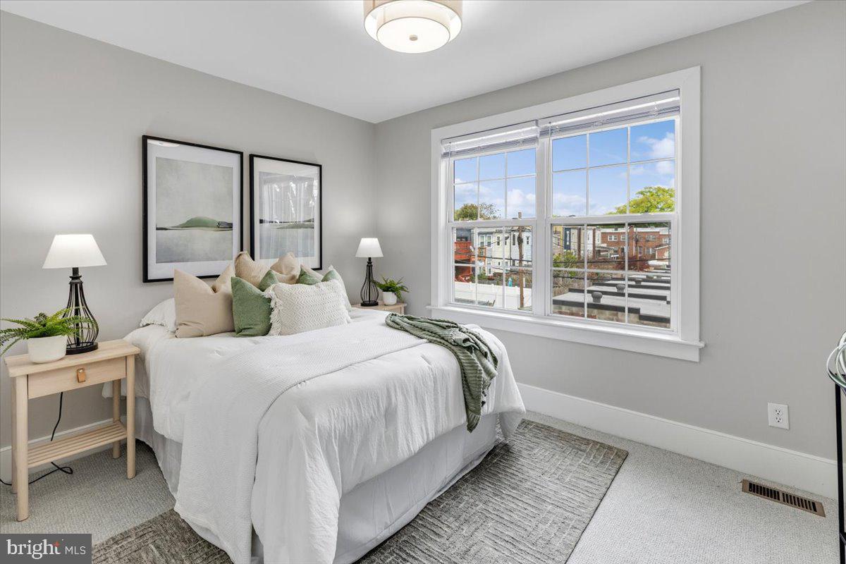 635 20th Street Northeast Washington, DC 20002 - Photo 20 of 33 a bedroom with a bed lamp and window