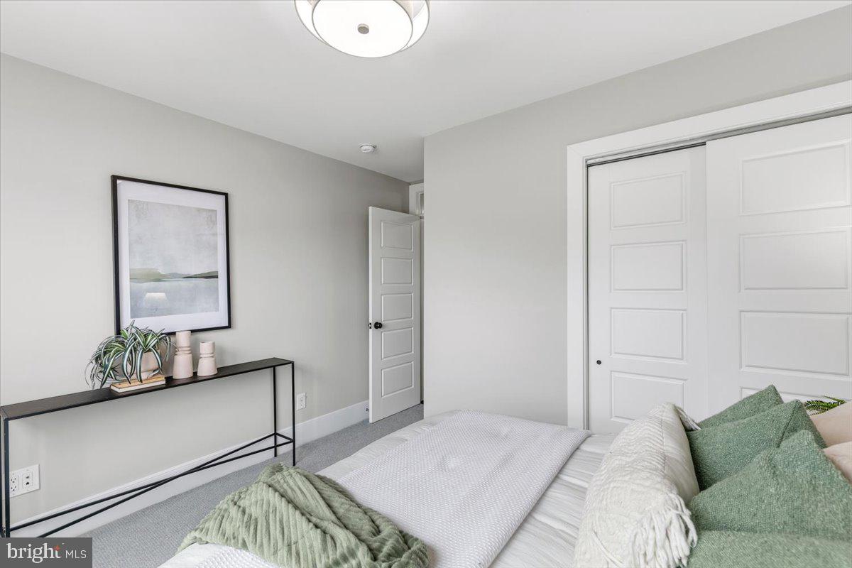 635 20th Street Northeast Washington, DC 20002 - Photo 21 of 33 a bedroom with a bed and a mirror on the dresser