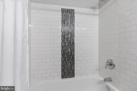 a bathroom with a bathtub and shower