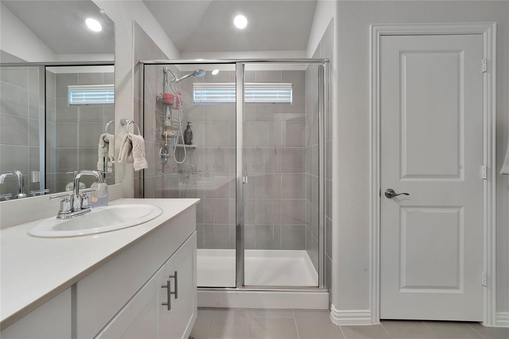 1817 Berry Rdg Trail Aubrey, TX 76227 - Photo 17 of 30 a bathroom with a shower sink and mirror