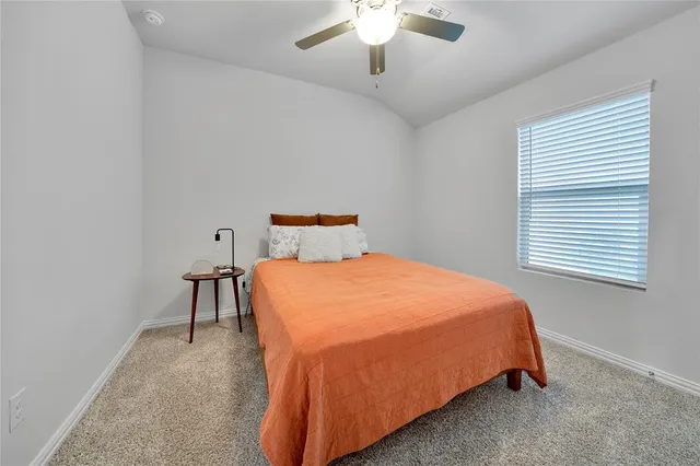 a bedroom with a bed and window