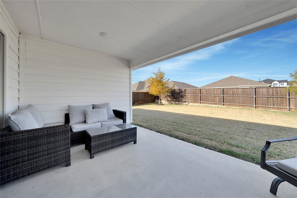 1817 Berry Rdg Trail Aubrey, TX 76227 - Photo 23 of 30 a view of living room kitchen with furniture and wooden floor