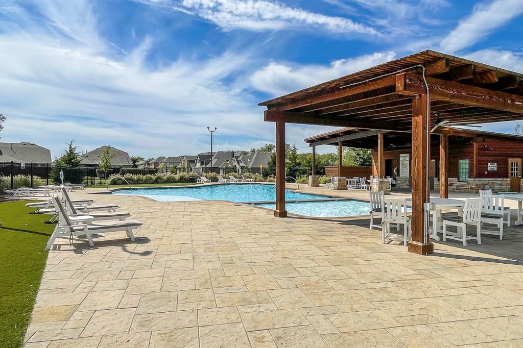 1817 Berry Rdg Trail Aubrey, TX 76227 - Photo 27 of 30 a view of a patio with a table and chairs