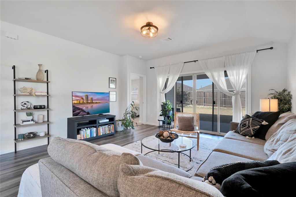 1817 Berry Rdg Trail Aubrey, TX 76227 - Photo 4 of 30 a living room with furniture a rug and a large window
