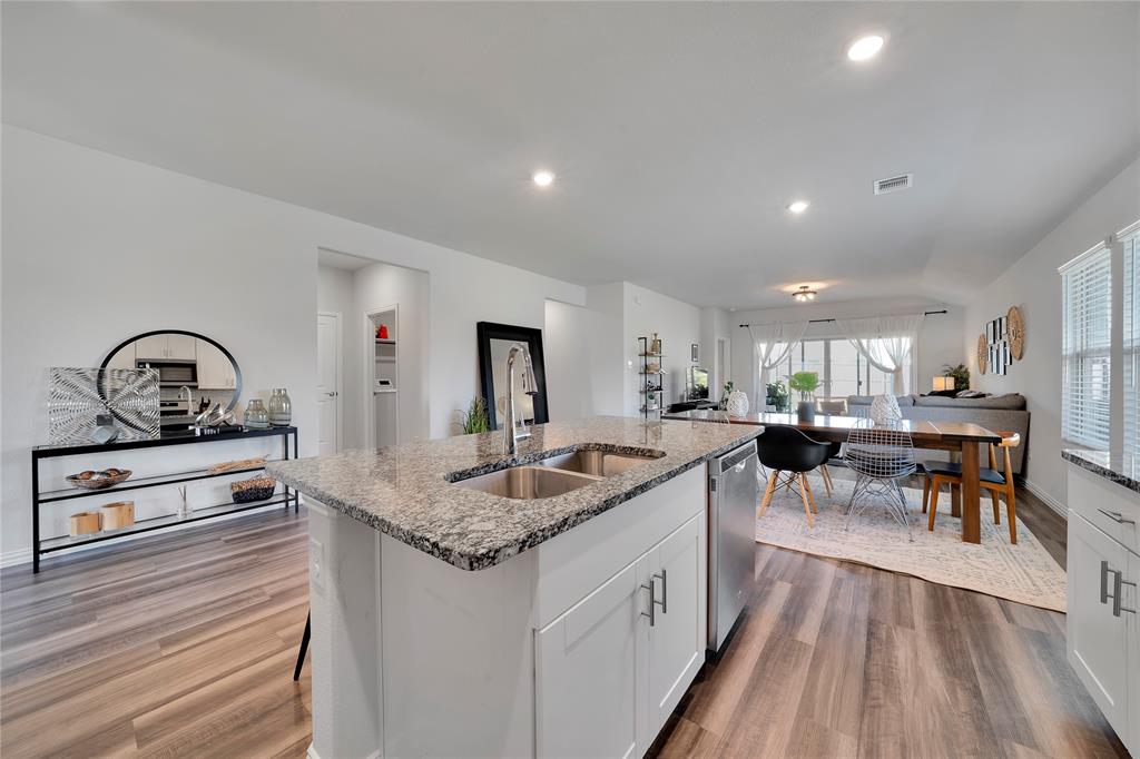 1817 Berry Rdg Trail Aubrey, TX 76227 - Photo 9 of 30 a kitchen with stainless steel appliances granite countertop sink stove top oven and cabinets