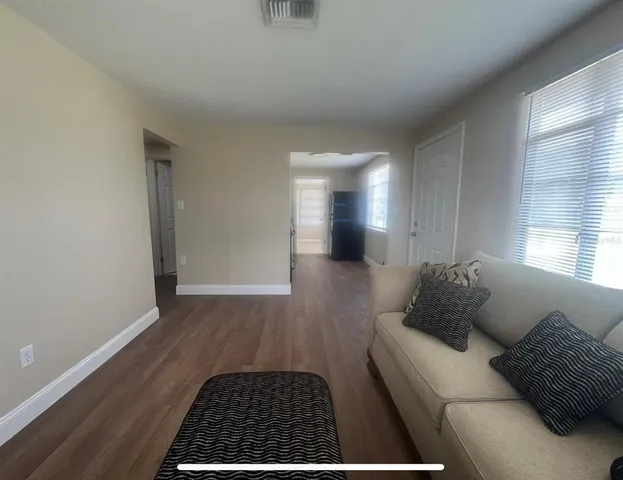 a living room with furniture and a rug