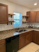 3826 Exeter Lane Lakeland, FL 33809 - Photo 3 of 10 a kitchen with stainless steel appliances granite countertop a sink stove and cabinets