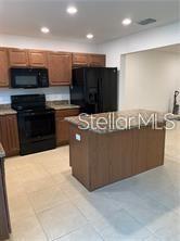 3826 Exeter Lane Lakeland, FL 33809 - Photo 5 of 10 a kitchen with stainless steel appliances a counter top space