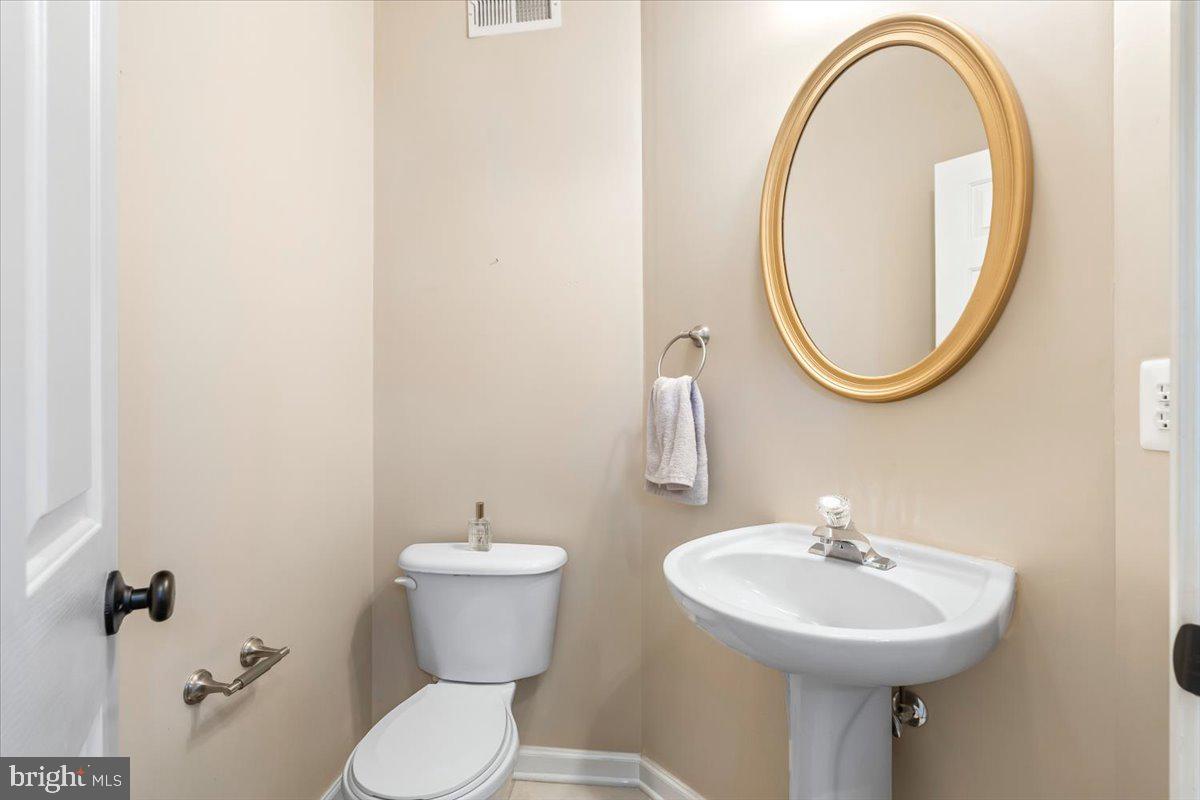 1729 Emory Street Frederick, MD 21701 - Photo 12 of 50 a bathroom with a sink a mirror and a toilet