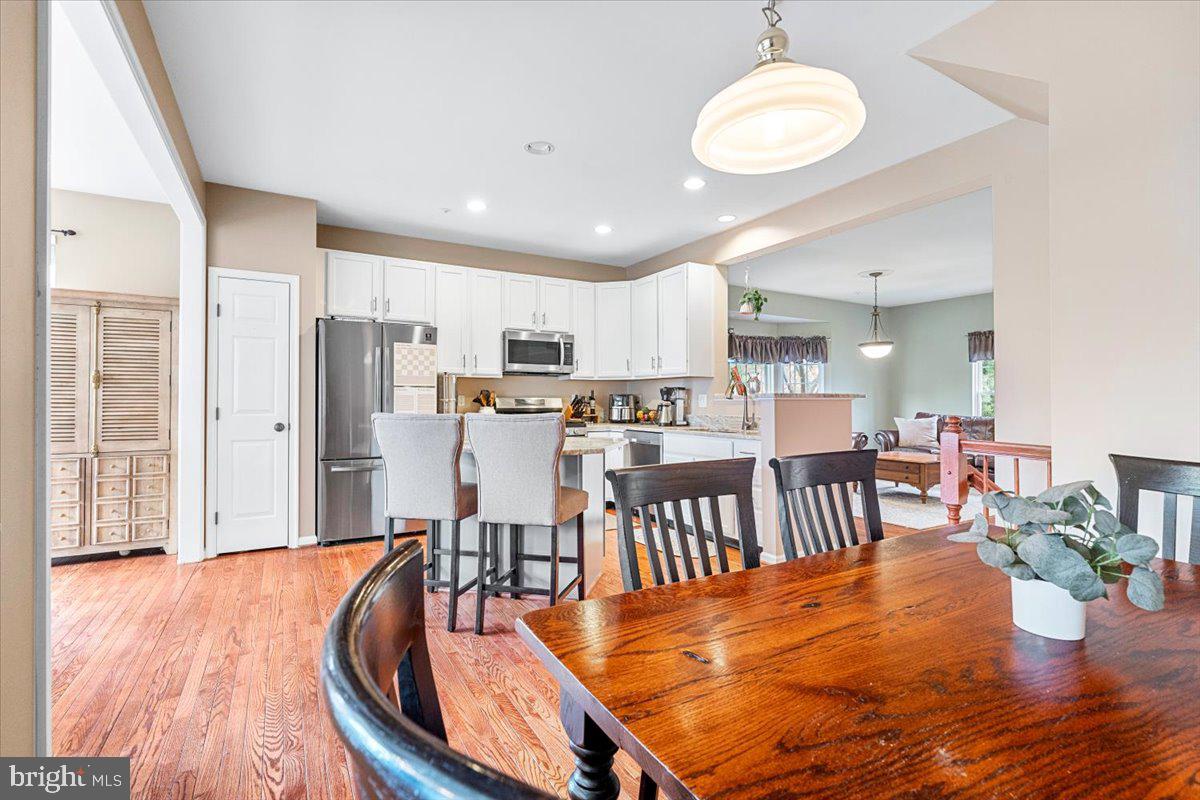 1729 Emory Street Frederick, MD 21701 - Photo 13 of 50 a dining room dining table chairs wooden floor and a kitchen view