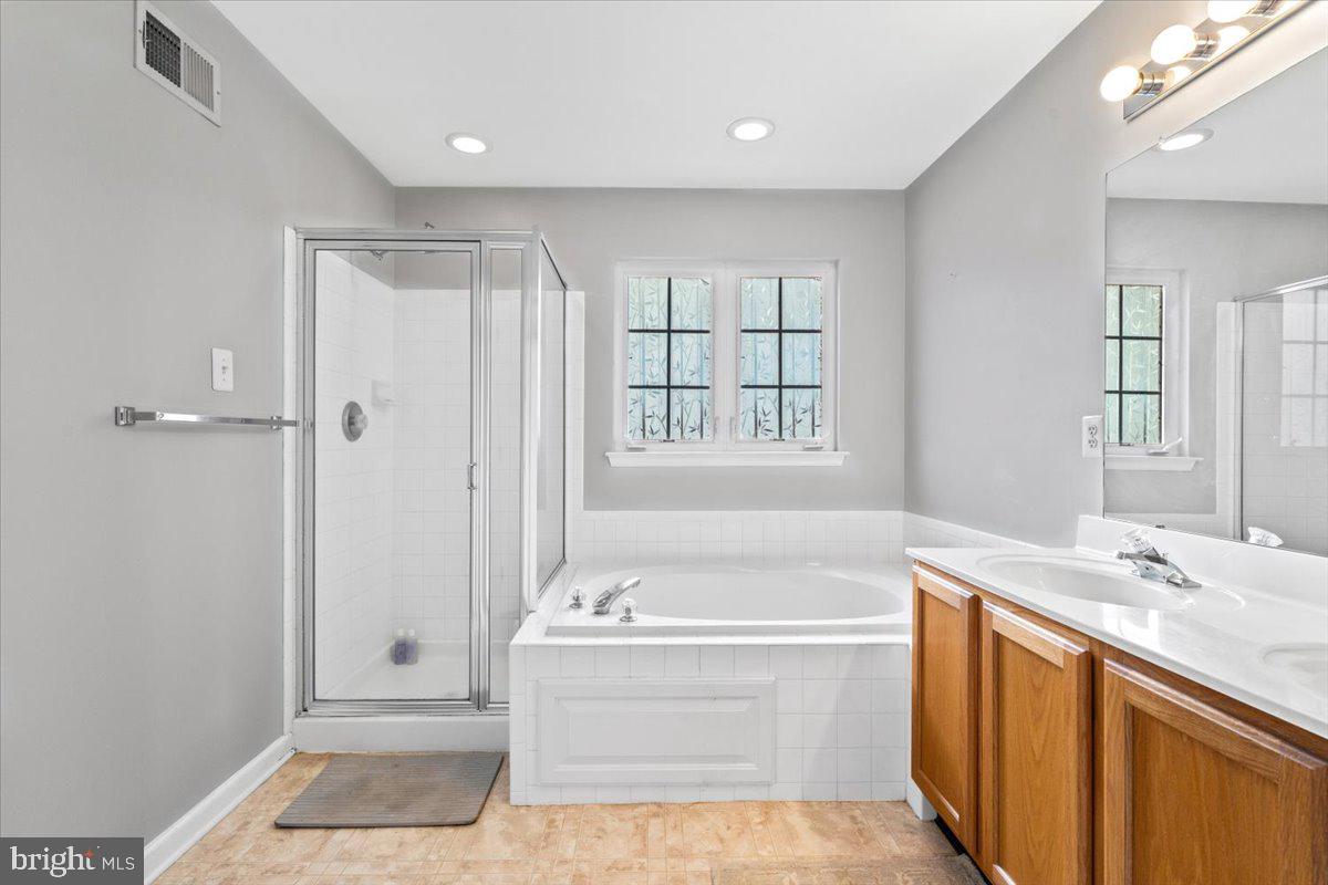 1729 Emory Street Frederick, MD 21701 - Photo 21 of 50 a spacious bathroom with a tub sink shower and mirror