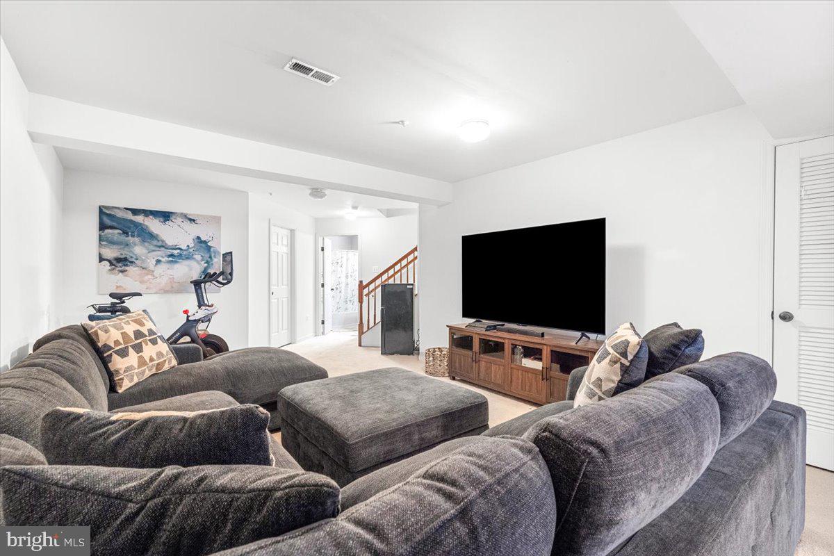 1729 Emory Street Frederick, MD 21701 - Photo 28 of 50 a living room with furniture and a flat screen tv