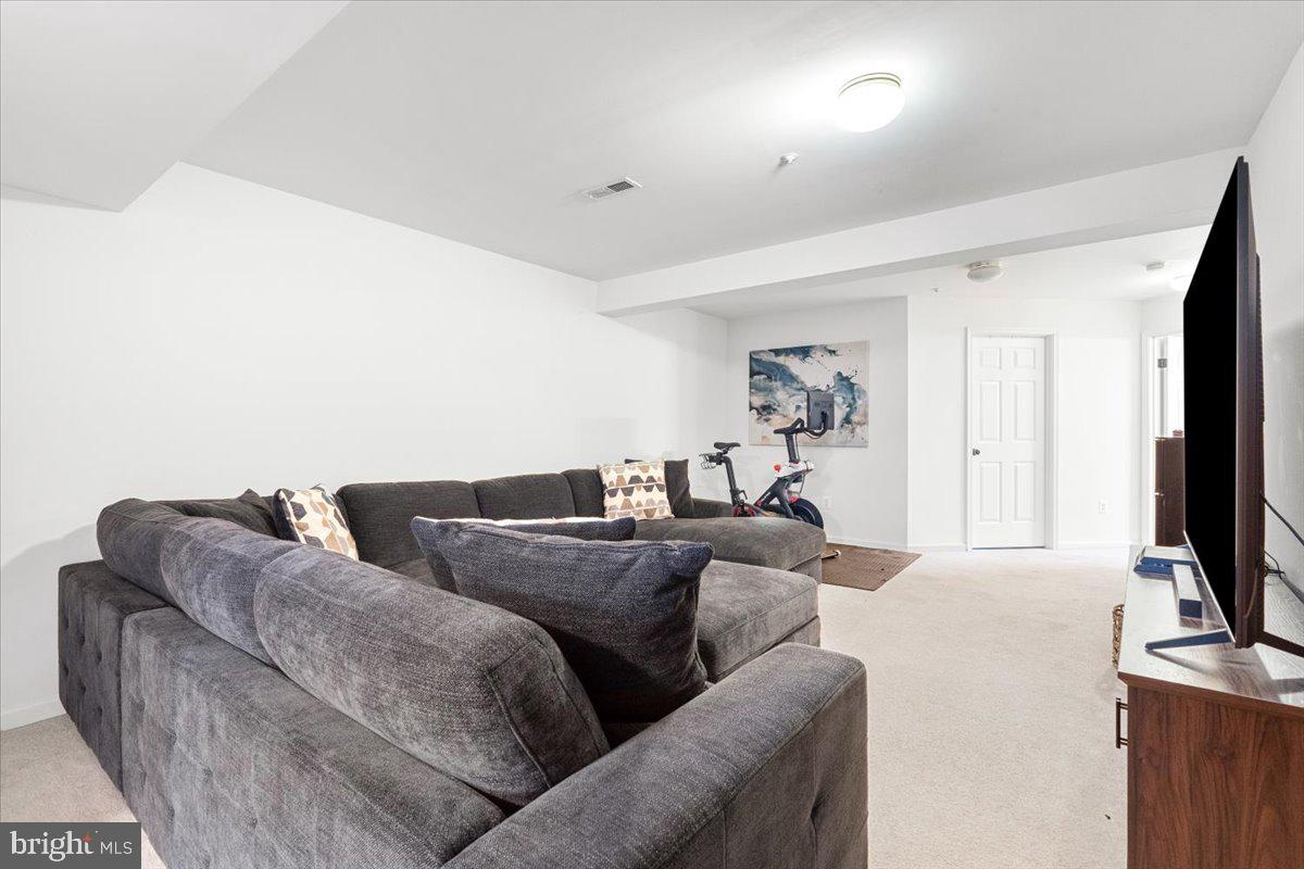 1729 Emory Street Frederick, MD 21701 - Photo 29 of 50 a living room with furniture and a flat screen tv