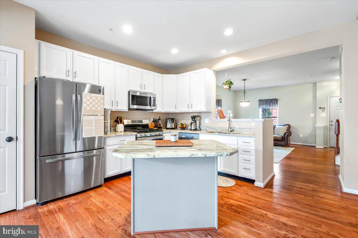 1729 Emory Street Frederick, MD 21701 - Photo 3 of 50 a kitchen with stainless steel appliances granite countertop a refrigerator a stove top oven a sink dishwasher and a refrigerator