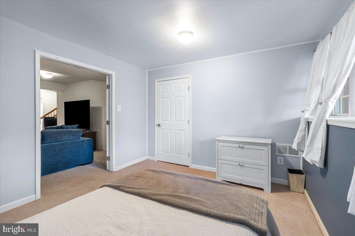 1729 Emory Street Frederick, MD 21701 - Photo 32 of 50 a bedroom with a bed and wooden floor