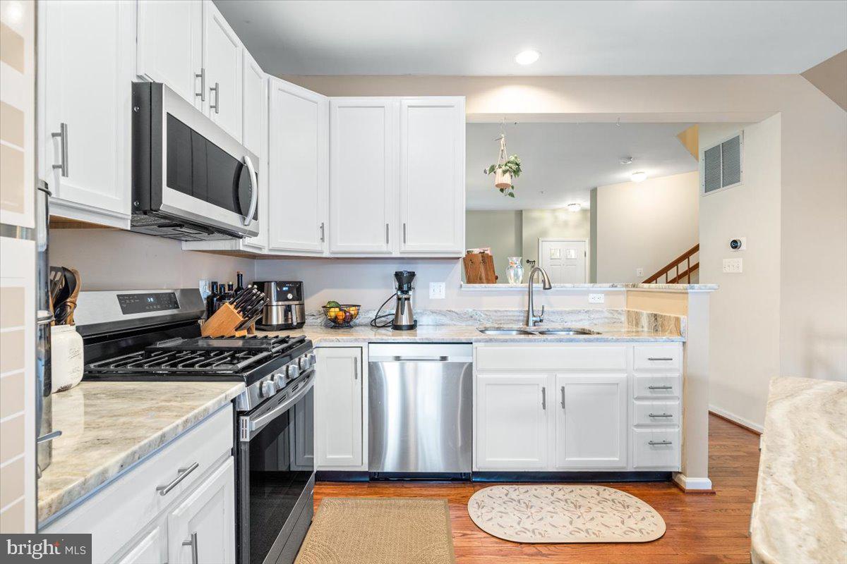 1729 Emory Street Frederick, MD 21701 - Photo 6 of 50 a kitchen with stainless steel appliances granite countertop a stove a sink and a microwave