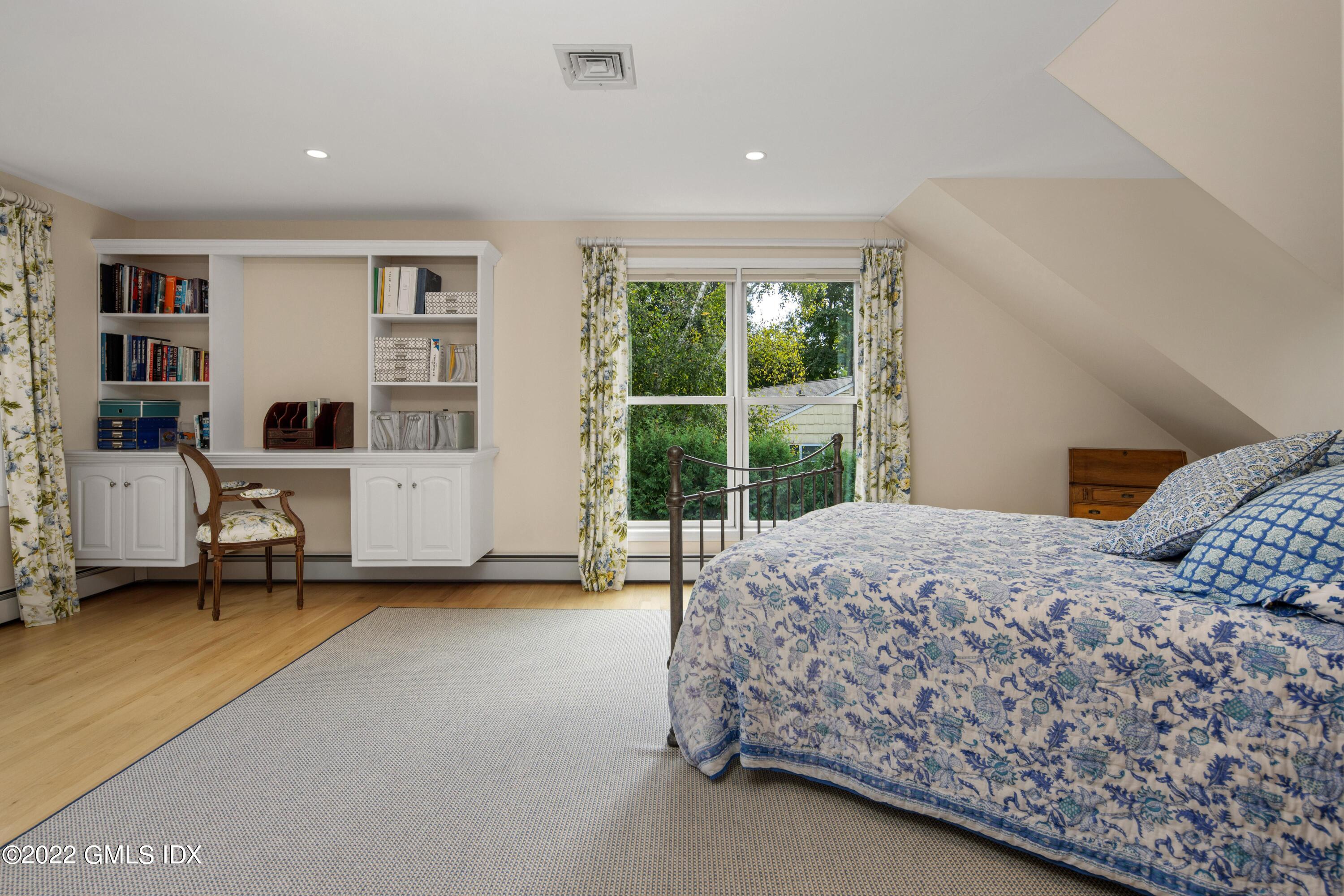 27 Rustic View Road Greenwich, CT 06830 - Photo 17 of 37 a bedroom with a bed and a large window