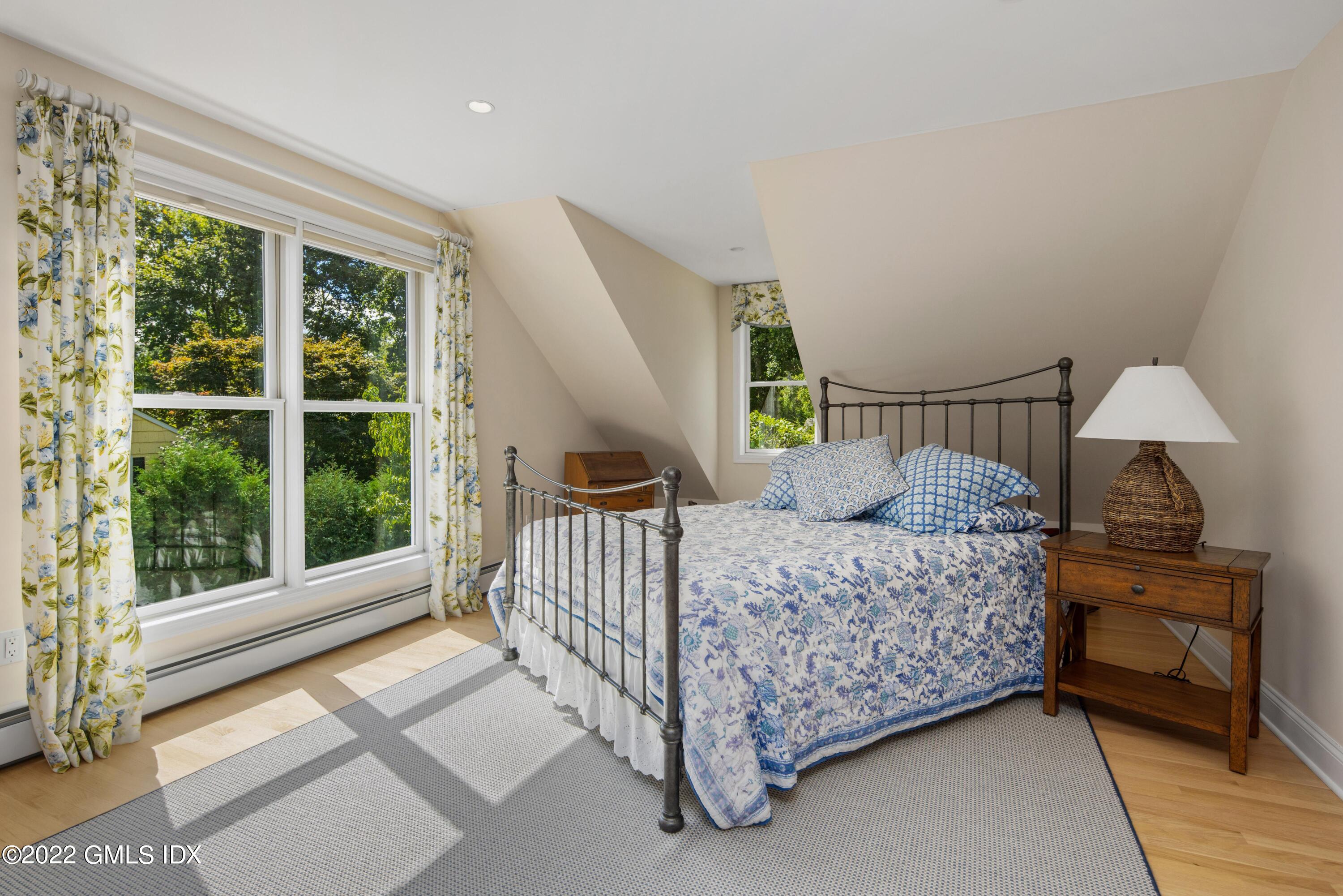 27 Rustic View Road Greenwich, CT 06830 - Photo 18 of 37 a bed room with a bed and a window