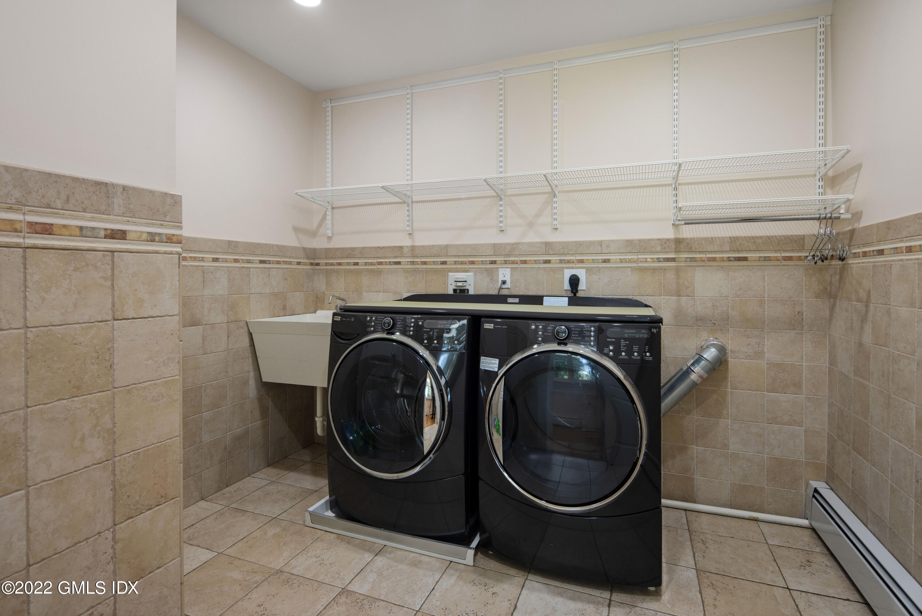 27 Rustic View Road Greenwich, CT 06830 - Photo 21 of 37 a utility room with dryer and washer