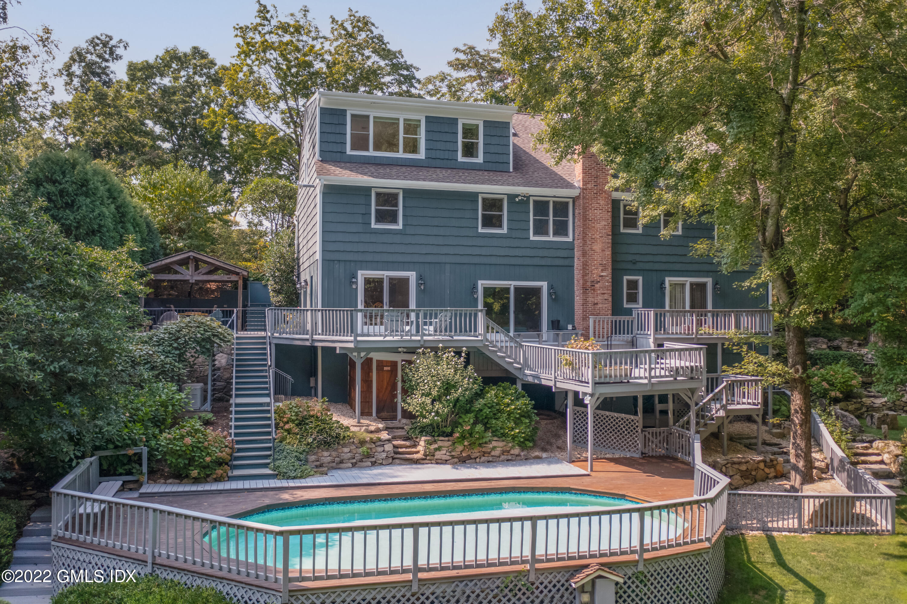 27 Rustic View Road Greenwich, CT 06830 - Photo 31 of 37 a front view of a house with a garden