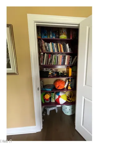 a living room with fish tank and a bookshelf