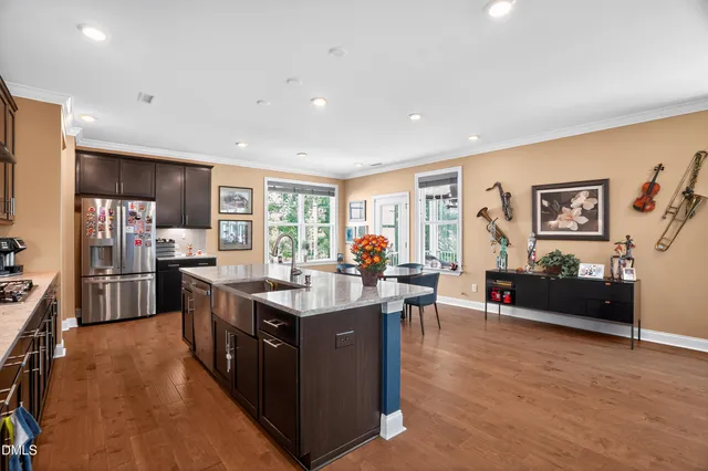a view of a living room kitchen and a wooden floor