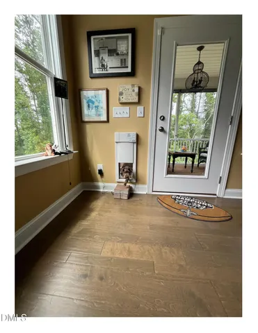 a view of an entryway with wooden floor