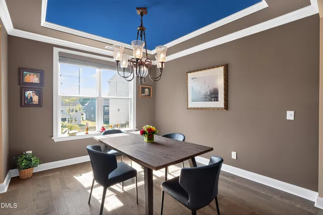 a view of a dining room with a table and chairs