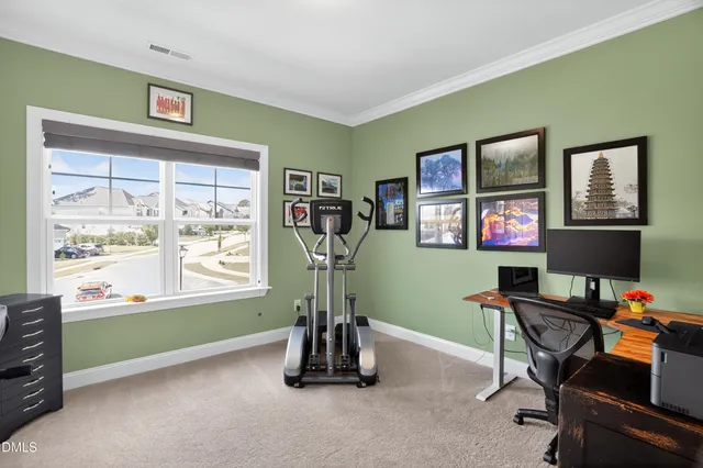 a view of a workspace with furniture and a window