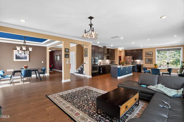 a living room with furniture a dining table and chairs in it