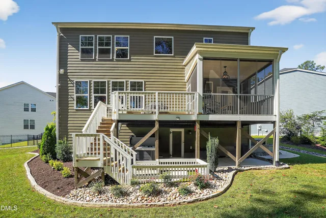 a view of a house with a small yard and potted plants