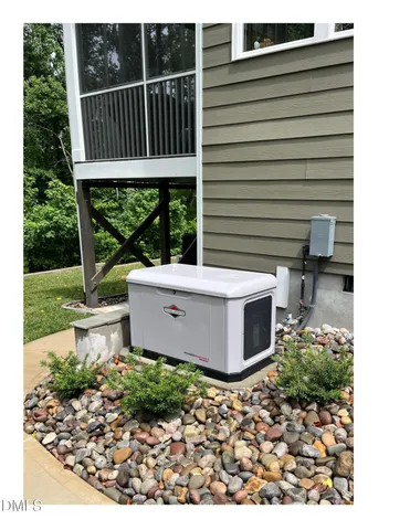 a view of a deck with a chair and potted plants