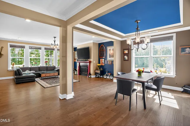 a dining room with furniture and wooden floor