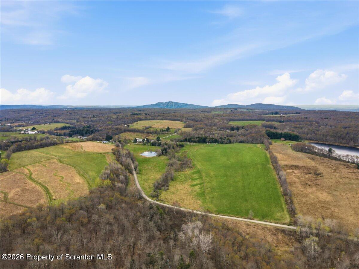 1140 Ball Pond Road Thompson, PA 18465 - Photo 36 of 68 an aerial view of residential houses with outdoor space and ocean view