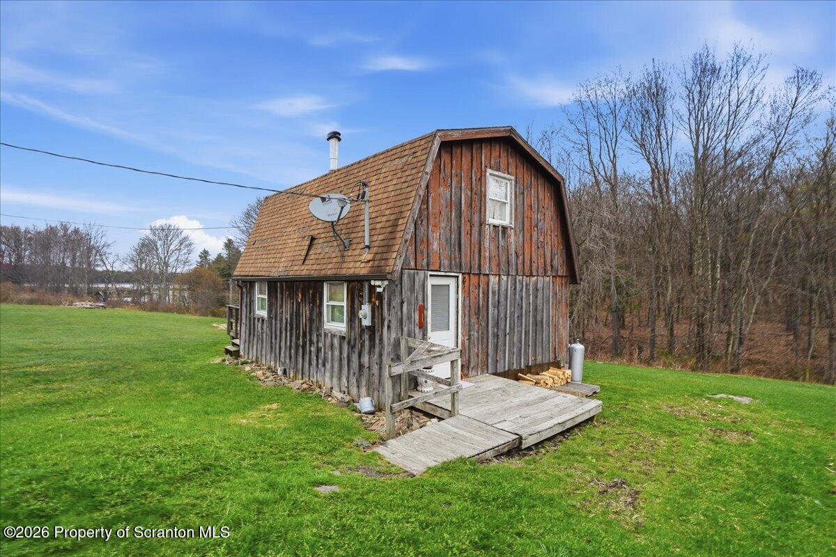 1140 Ball Pond Road Thompson, PA 18465 - Photo 53 of 68 a view of a house with backyard and garden