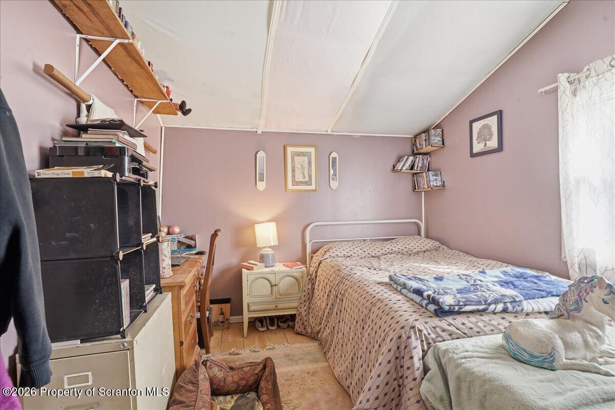 1140 Ball Pond Road Thompson, PA 18465 - Photo 67 of 68 a bedroom with a bed and wooden floor